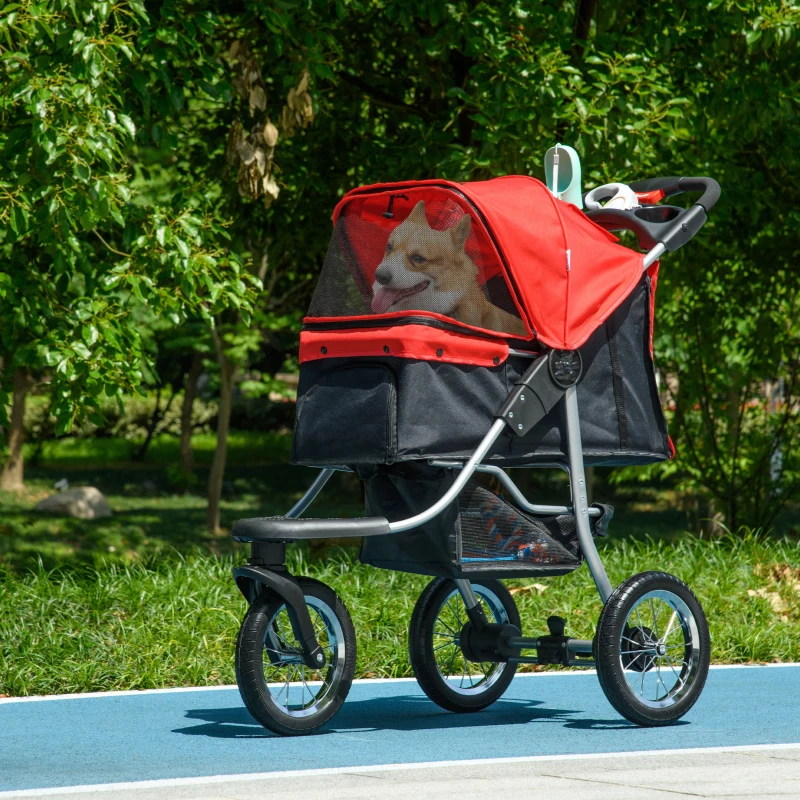 man pushing dog stroller on park pathway.