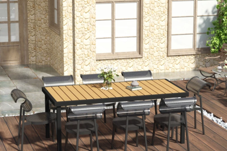 Outdoor dining table setup with chairs arranged on patio deck.