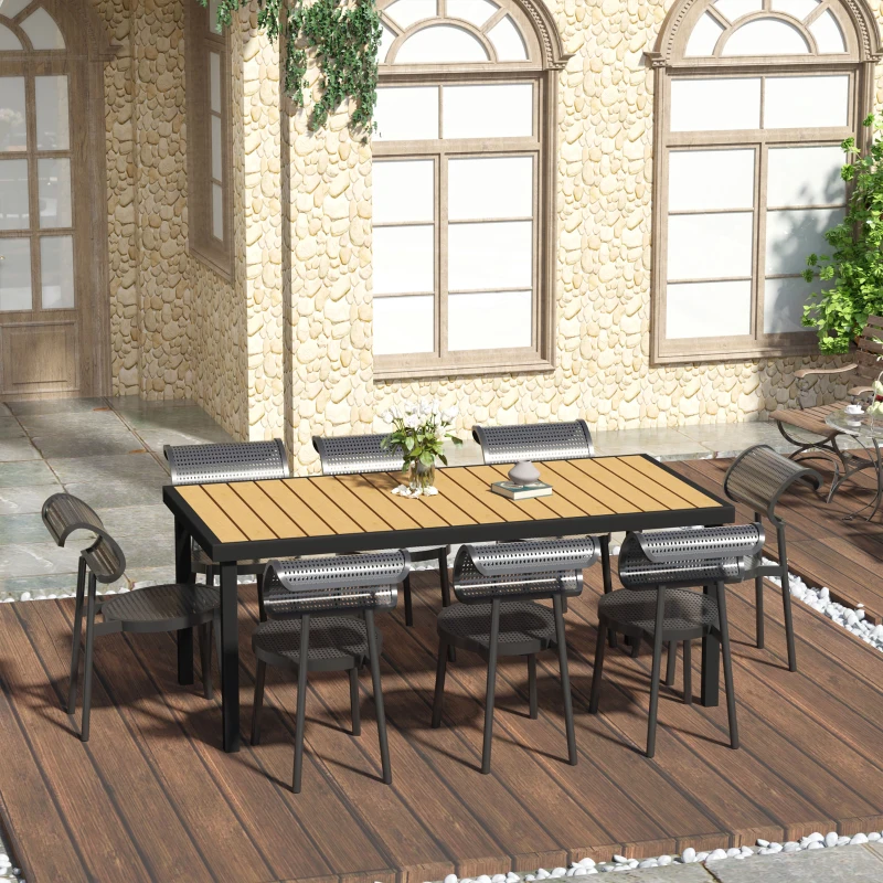 Outdoor dining table setup with chairs arranged on patio deck.
