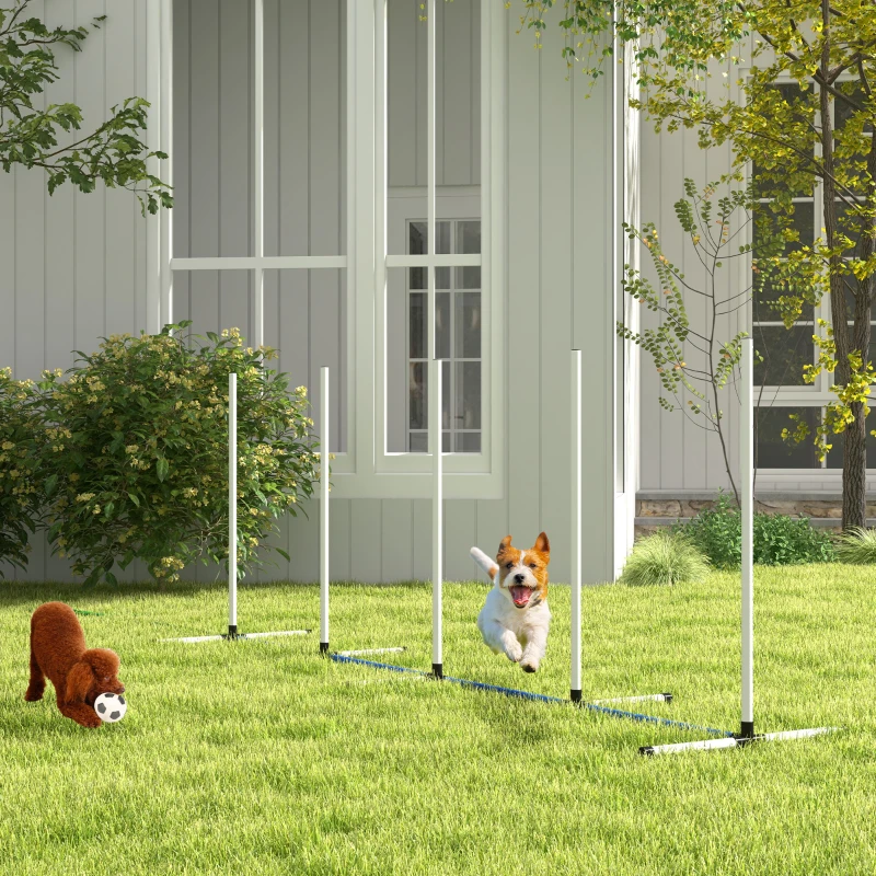 Dog weaving through outdoor agility poles on green lawn.