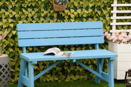 Blue wooden garden bench positioned outdoors on artificial grass.
