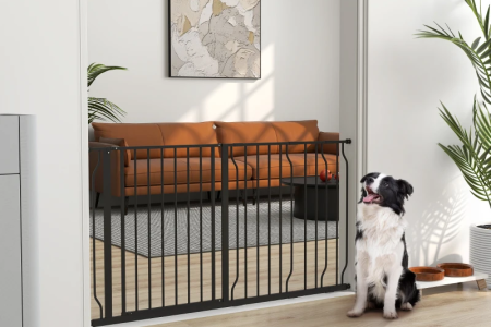 Dog sitting beside tall metal gate blocking access to living room.