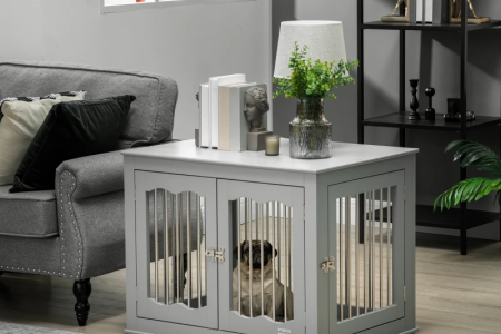 Furniture-style dog crate used as a side table beside a sofa.