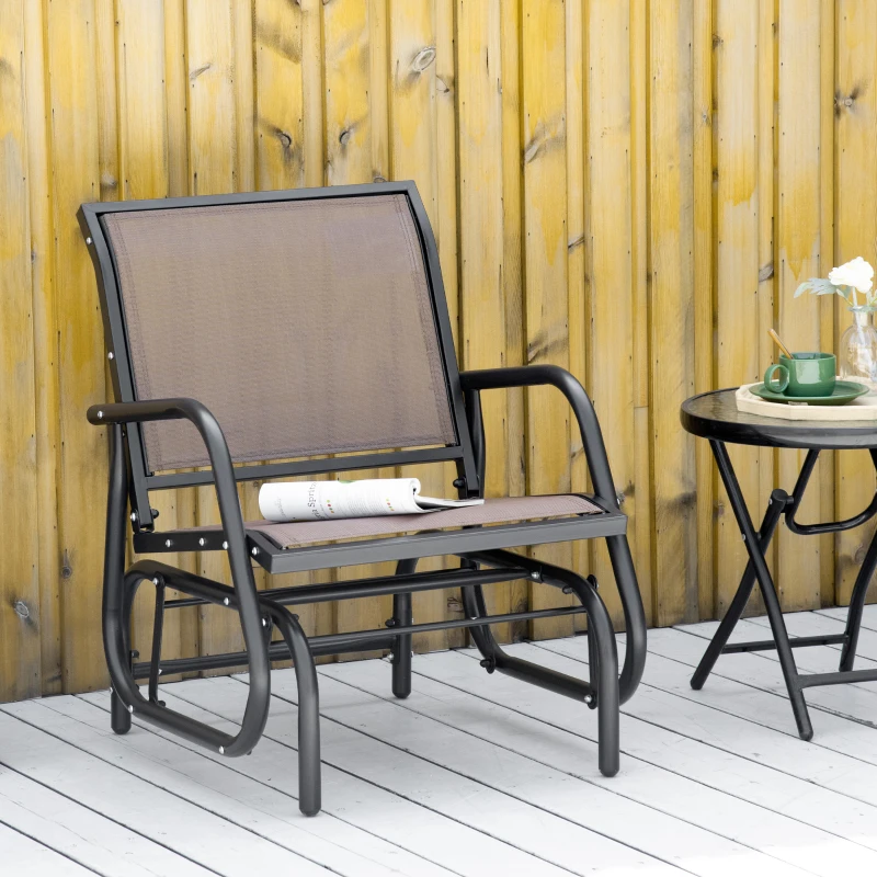 Outdoor mesh patio glider placed beside wooden wall.