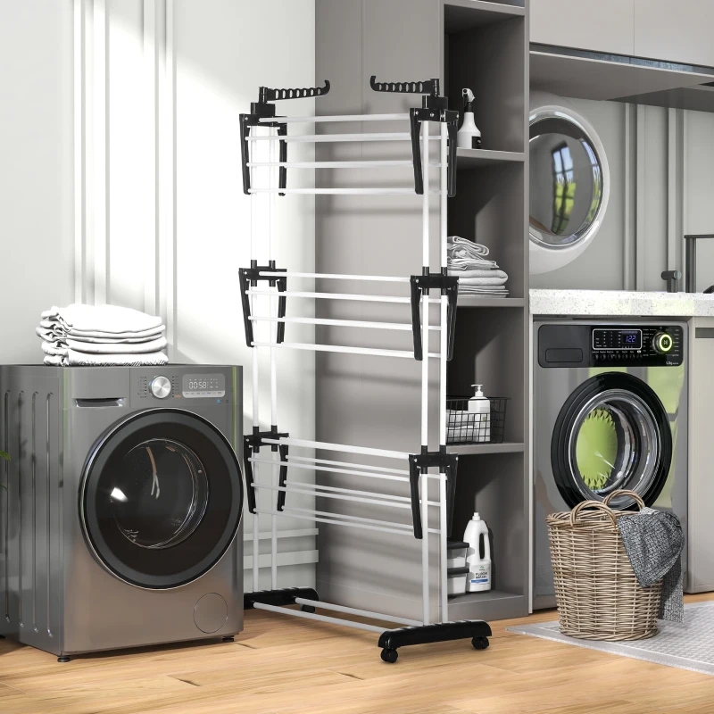 Foldable clothes drying rack placed in a laundry room beside washer and shelves.