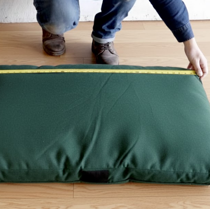 Measuring and planning the dimensions of the dog bed frame for proper sizing.