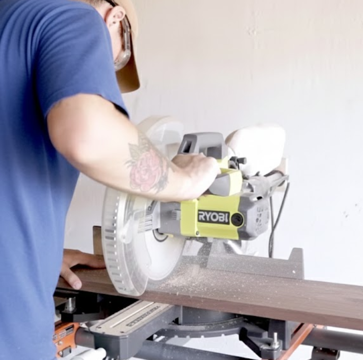 Cutting the side and front panels for the dog bed with a miter saw.