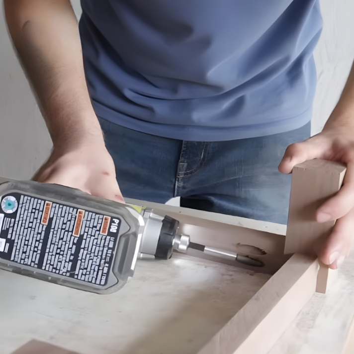 Securing the legs to the wooden dog bed frame with screws and glue.