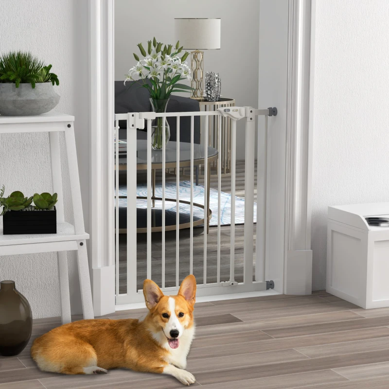 White wooden DIY dog gate with cross-brace design installed in a bright modern home entryway.