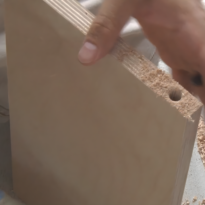 Wooden stair treads and risers being aligned and prepared for assembly on a workbench.